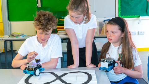 3 stem pupils and experimenting with two robots 