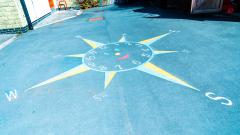 Photograph of a photograph of a compass painting  on the playground