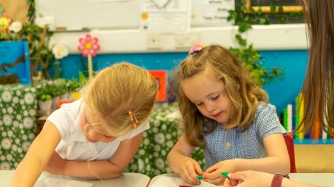 Two young girls learning about shapes 