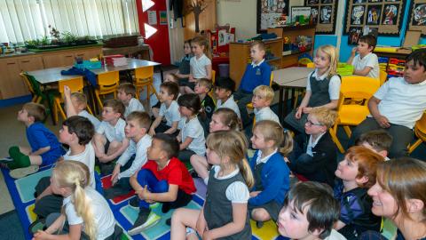 Pupils sat on the floor learning about bird nests