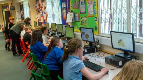 Pupils in the it suite sat down working at computers 