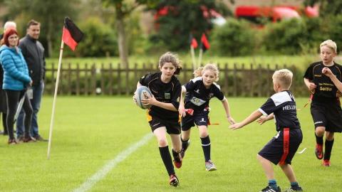 Boys and girls playing rugby