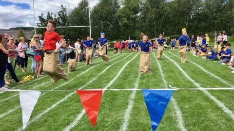 Children involved in a sack race on school sports day